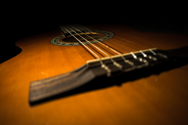 classic-guitar-with-black-background_78636-161